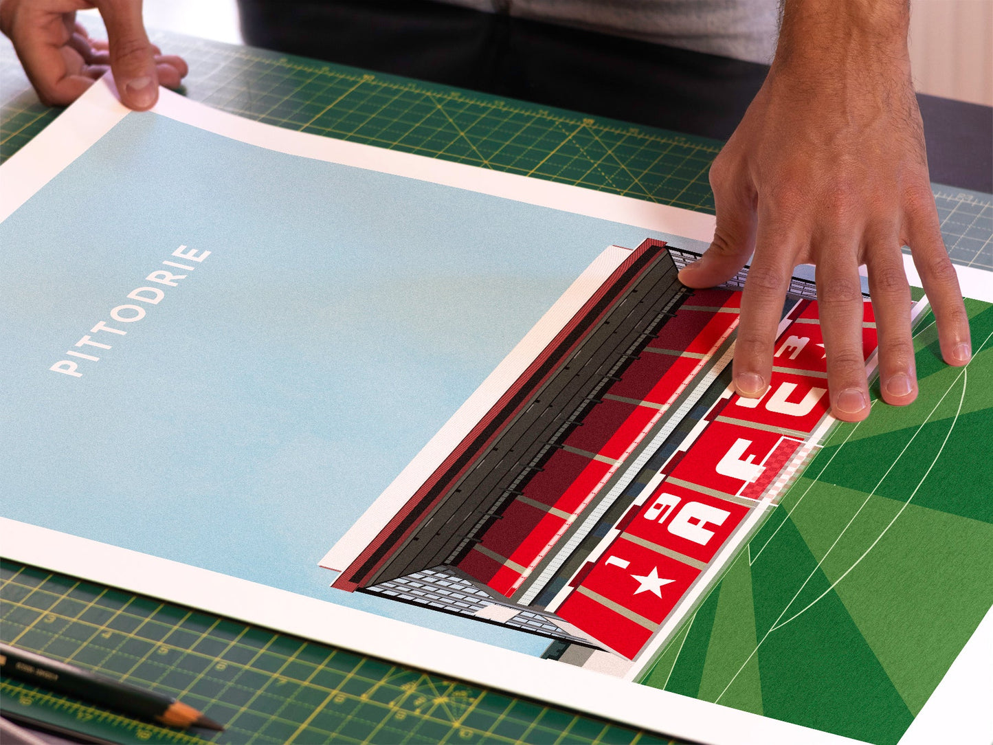 A photo in our printing studio, of one of our illustrated art prints of Pittodrie Stadium after it has been printed and is about to be packaged.