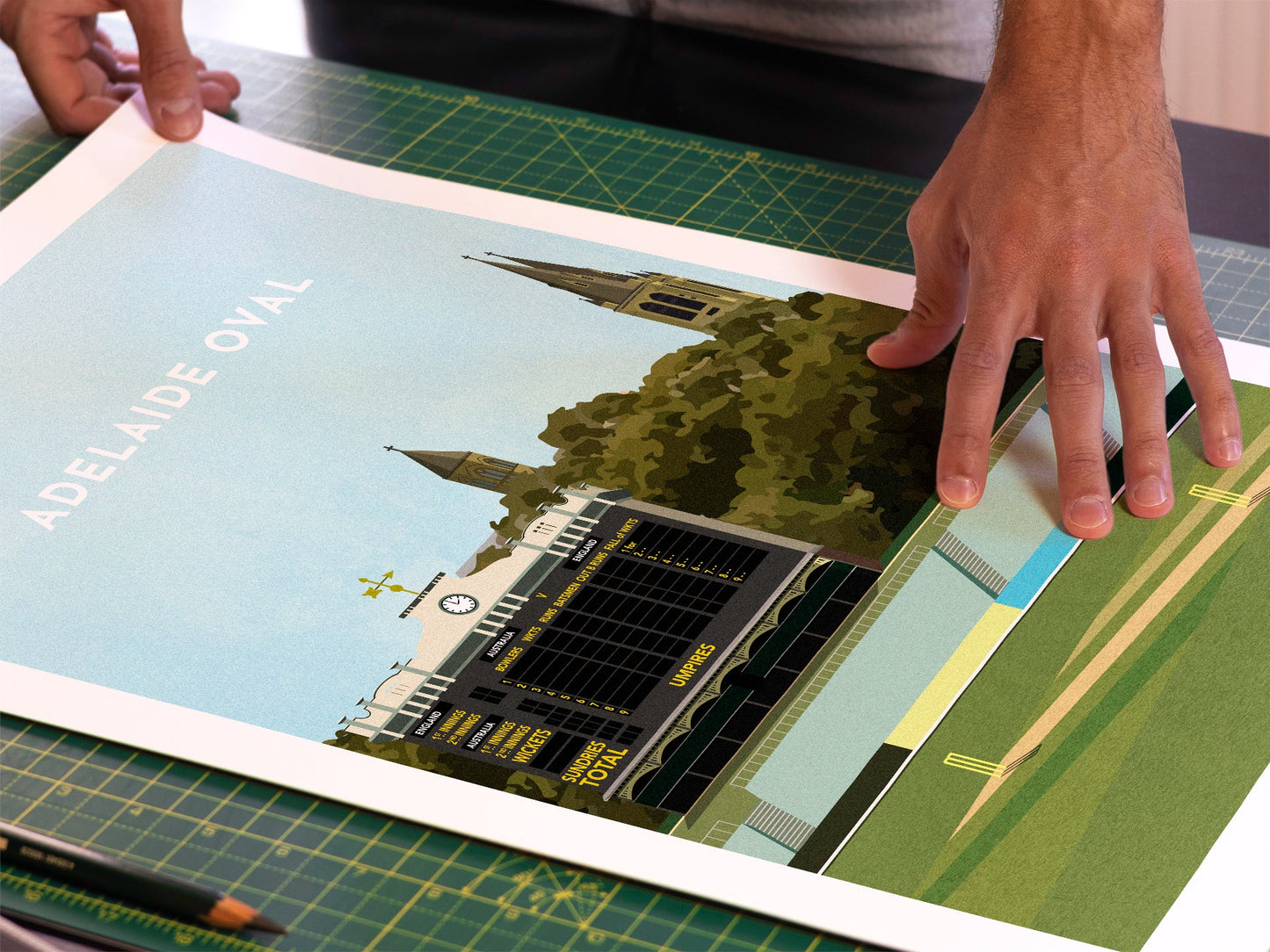 A photo in our printing studio, of one of our illustrated art prints of the Adelaide Oval cricket ground after it has been printed and is about to be packaged.