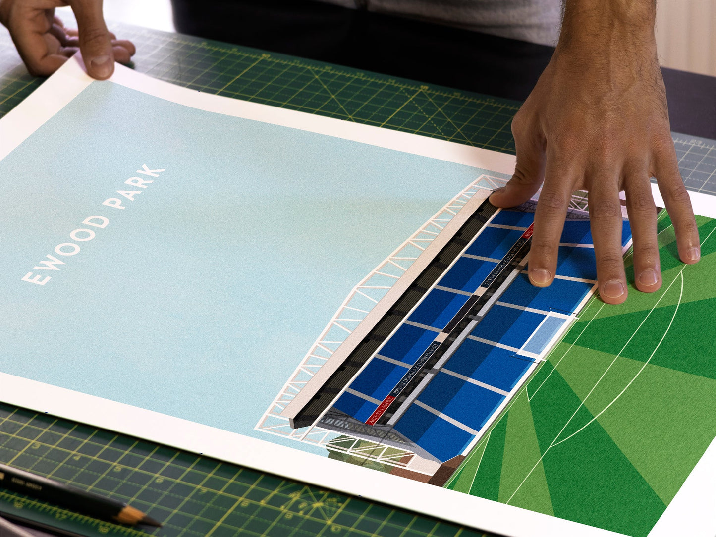 A photo in our printing studio, of one of our illustrated art prints of Ewood Park after it has been printed and is about to be packaged.