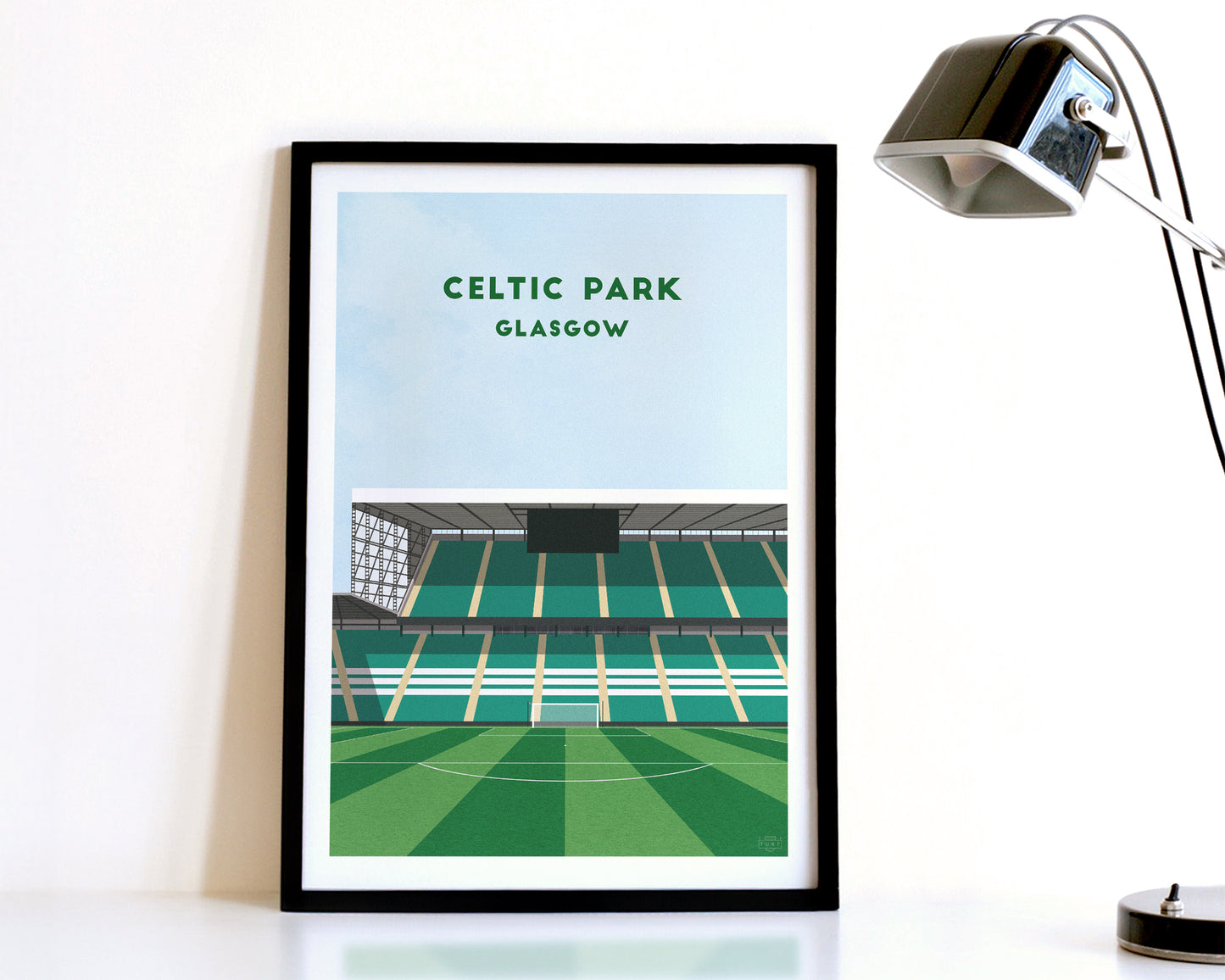 A modern style Celtic Print, featuring a contemporary illustration of their home stadium the Celtic Park in Glasgow, displayed within a black frame.