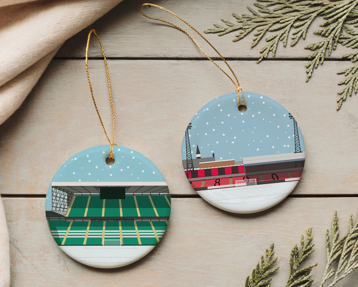 Ceramic Christmas bauble decorations featuring minimalist illustrations of football stadiums on each one, specifically Celtic's stadium, Celtic Park / Parkhead on the left bauble, and Bohemian FC's stadium, Dalymount Park on the right bauble.