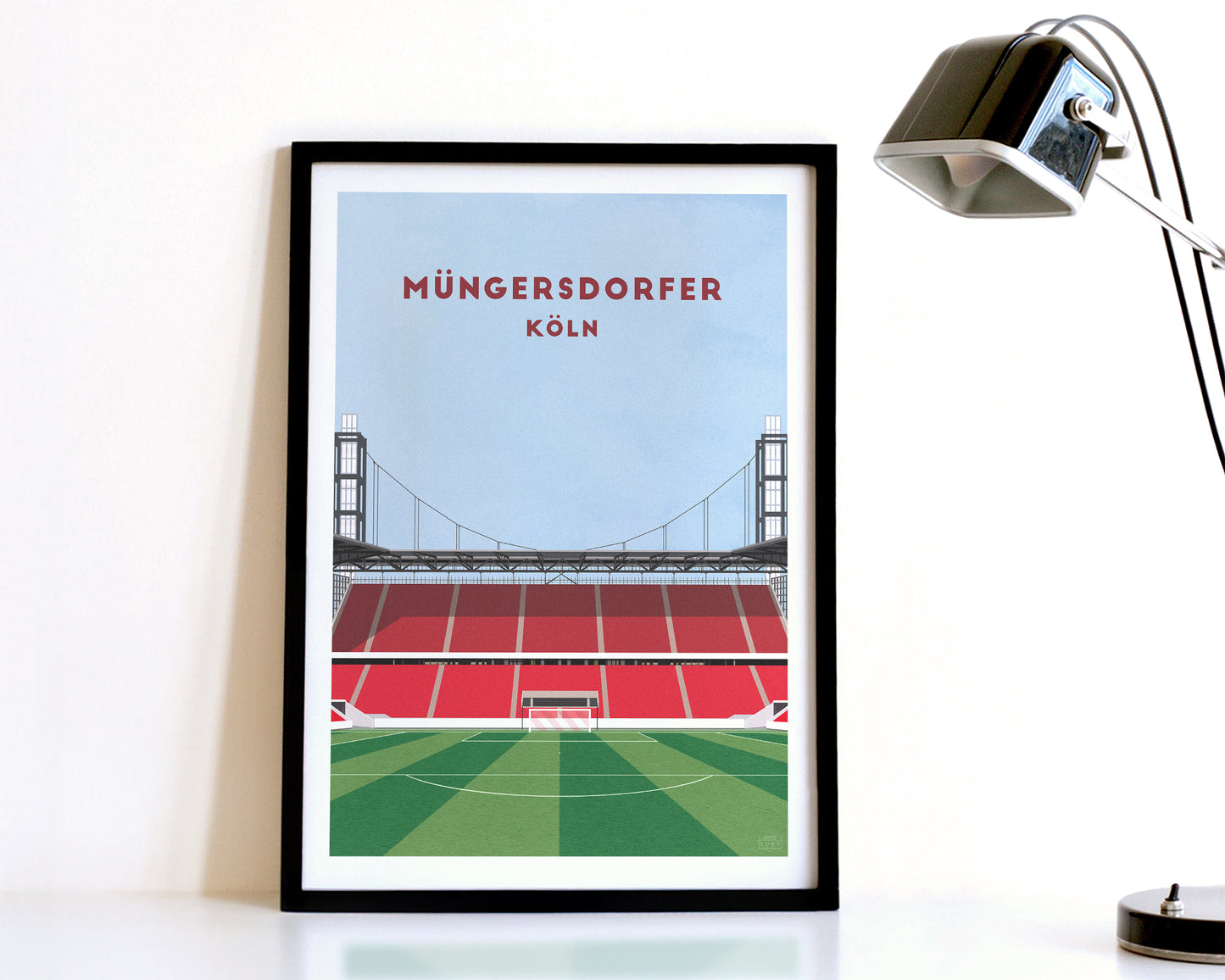 A modern style Cologne Print, featuring a contemporary illustration of their home stadium the Rhein Energie Stadion in Cologne, displayed within a black frame.