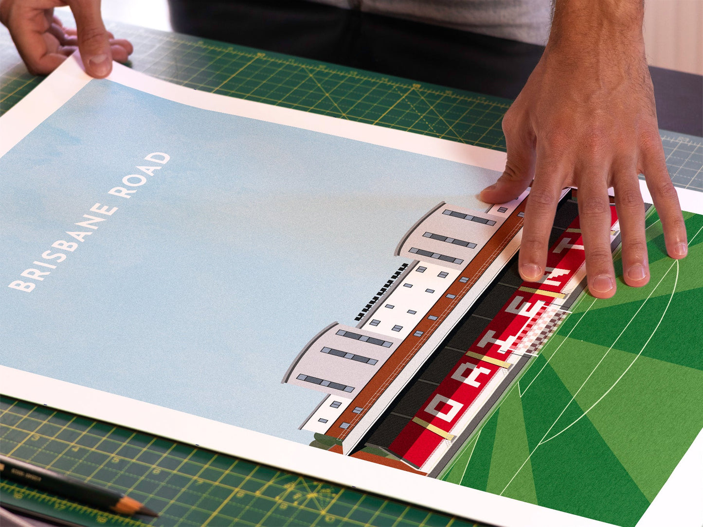 A photo in our printing studio, of one of our illustrated art prints of Brisbane Road after it has been printed and is about to be packaged.