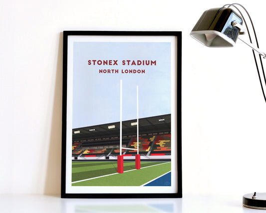 A modern style Saracens Print, featuring a contemporary illustration of their home stadium the StoneX Stadium in Barnet, North London, displayed within a black frame.
