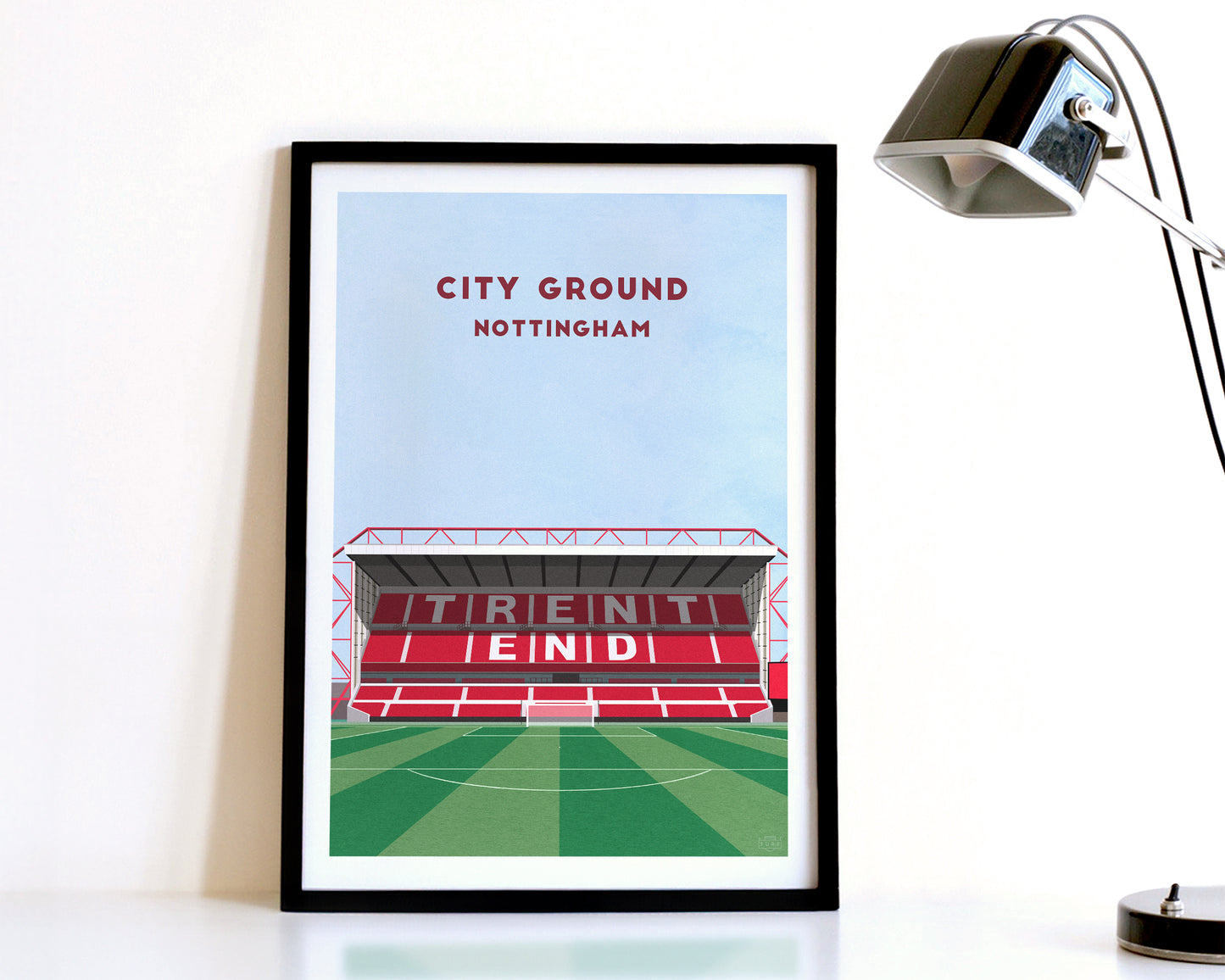A modern style Nottingham Forest Print, featuring a contemporary illustration of their home stadium the City Ground in Nottingham, displayed within a black frame.