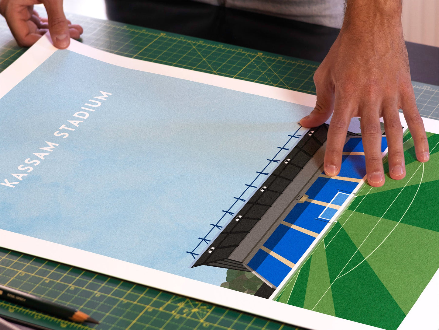 A photo in our printing studio, of one of our illustrated art prints of the Kassam Stadium after it has been printed and is about to be packaged.