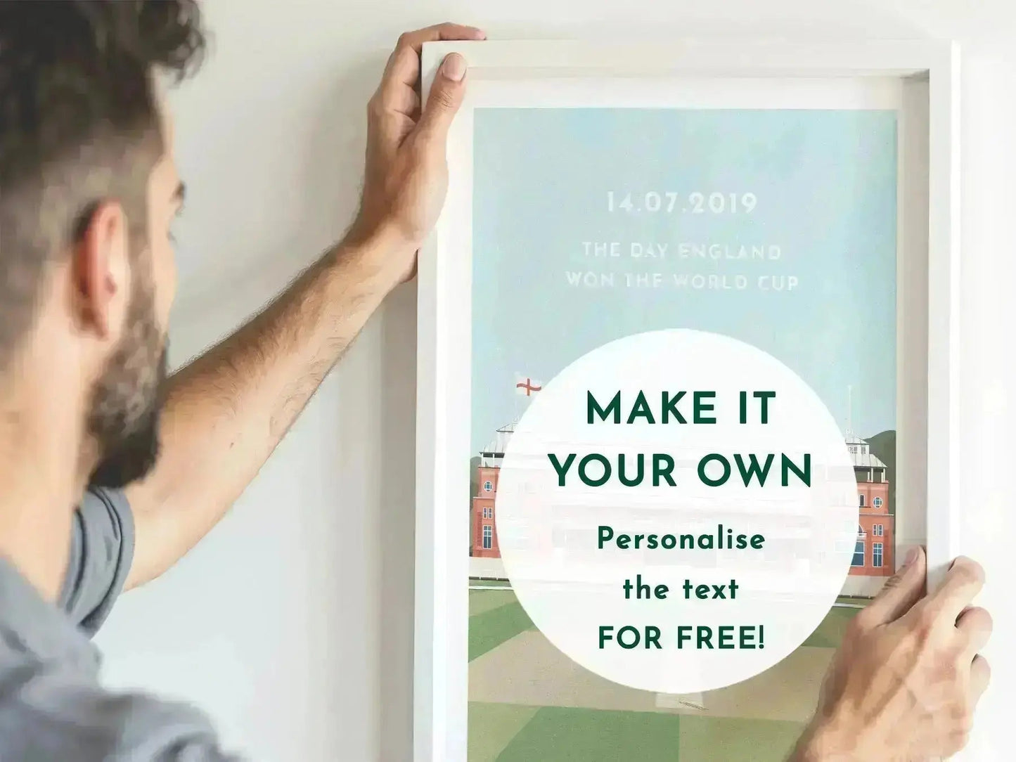 Person holding a framed poster with customizable text on a white wall.