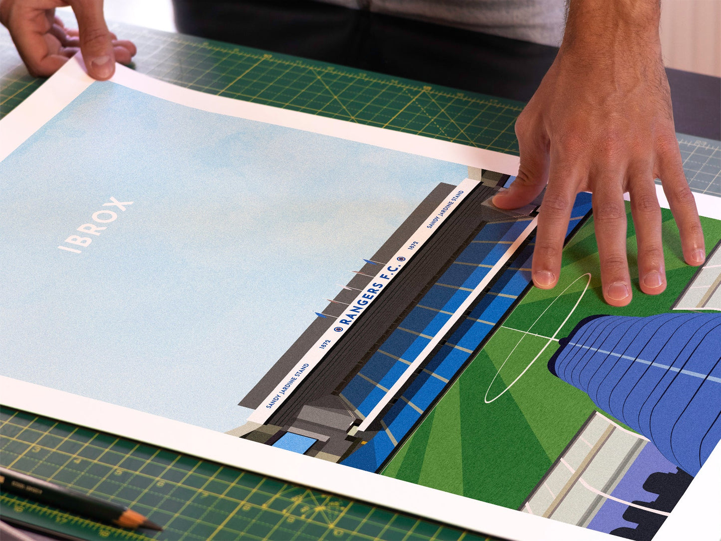 A photo in our printing studio, of one of our illustrated art prints of Ibrox after it has been printed and is about to be packaged.