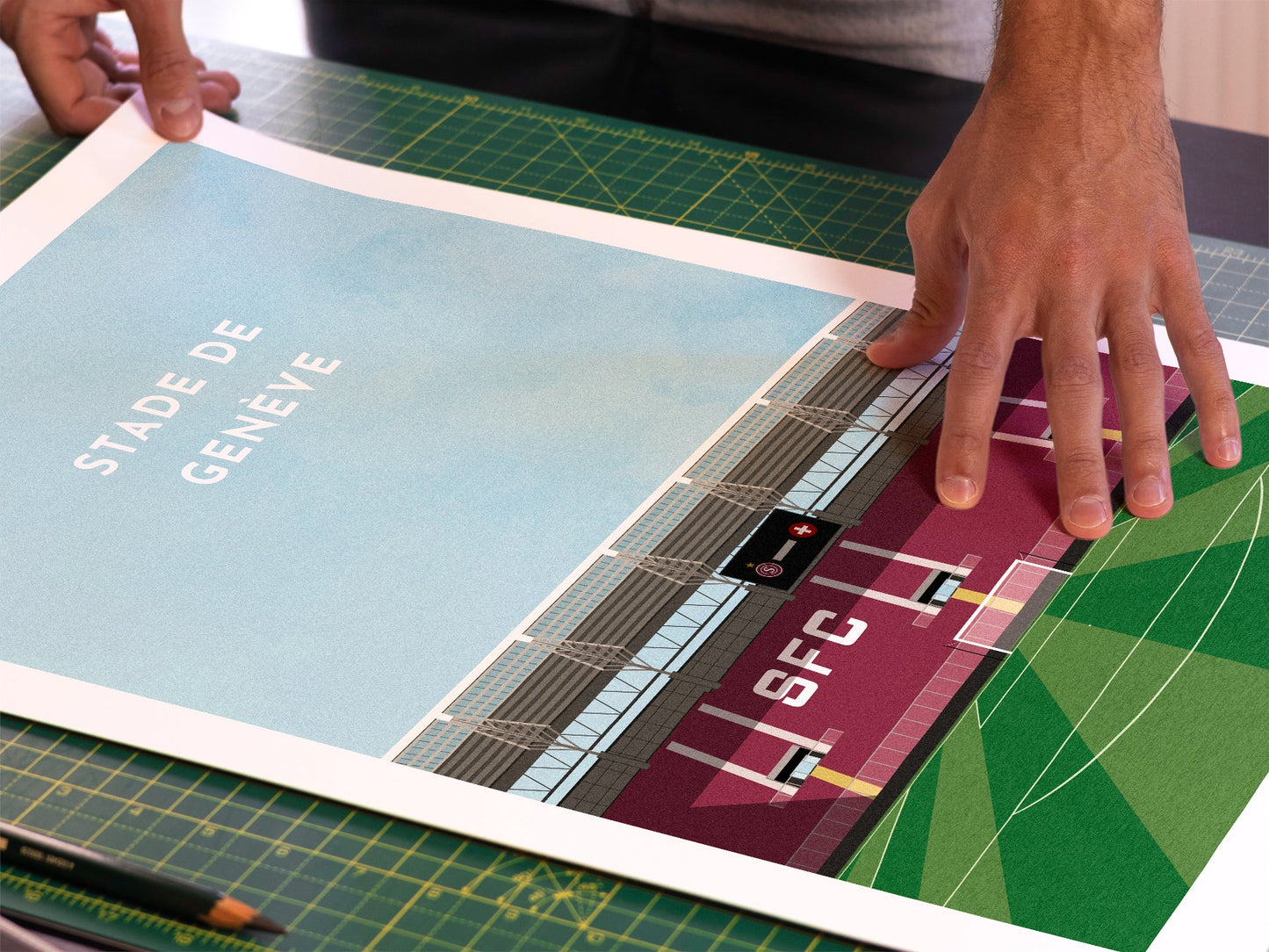 A photo in our printing studio, of one of our illustrated art prints of Stade De Genève after it has been printed and is about to be packaged.