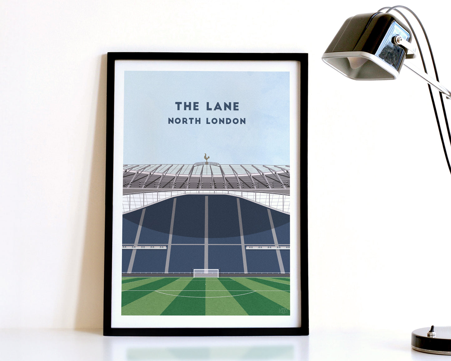 A modern style Tottenham Hotspur Print, featuring a contemporary illustration of their home stadium the Tottenham Hotspur Stadium in North London, displayed within a black frame.