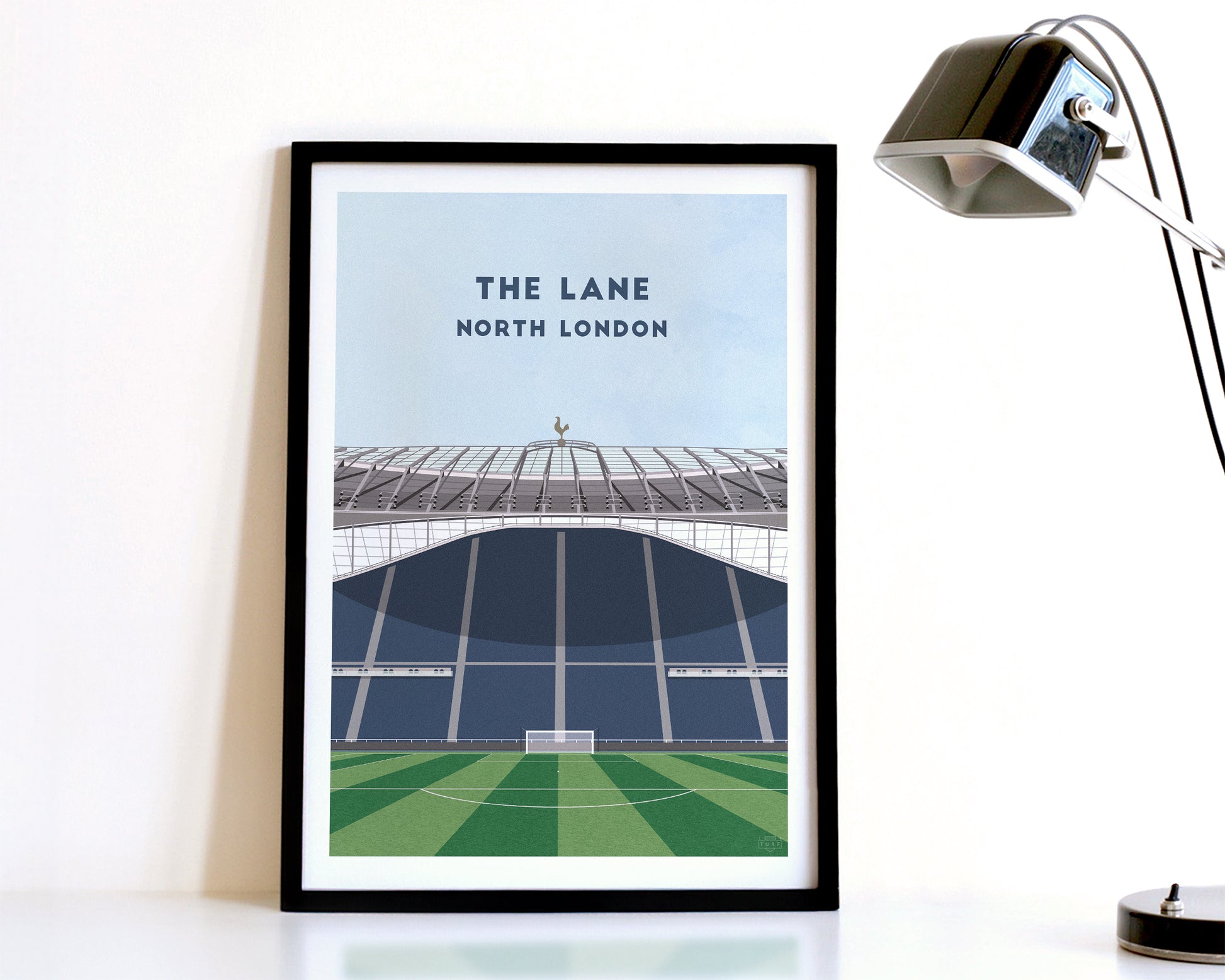 A modern style Tottenham Hotspur Print, featuring a contemporary illustration of their home stadium the Tottenham Hotspur Stadium in North London, displayed within a black frame.