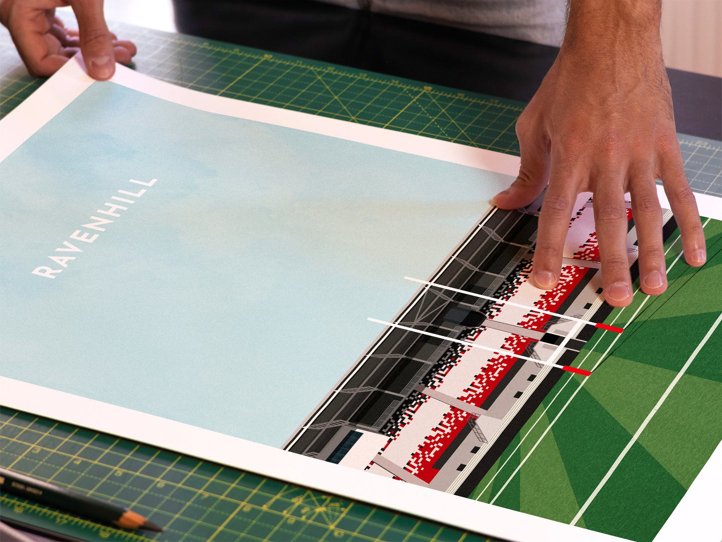 A photo in our printing studio, of one of our illustrated art prints of Ravenhill /Kingspan Stadium after it has been printed and is about to be packaged.