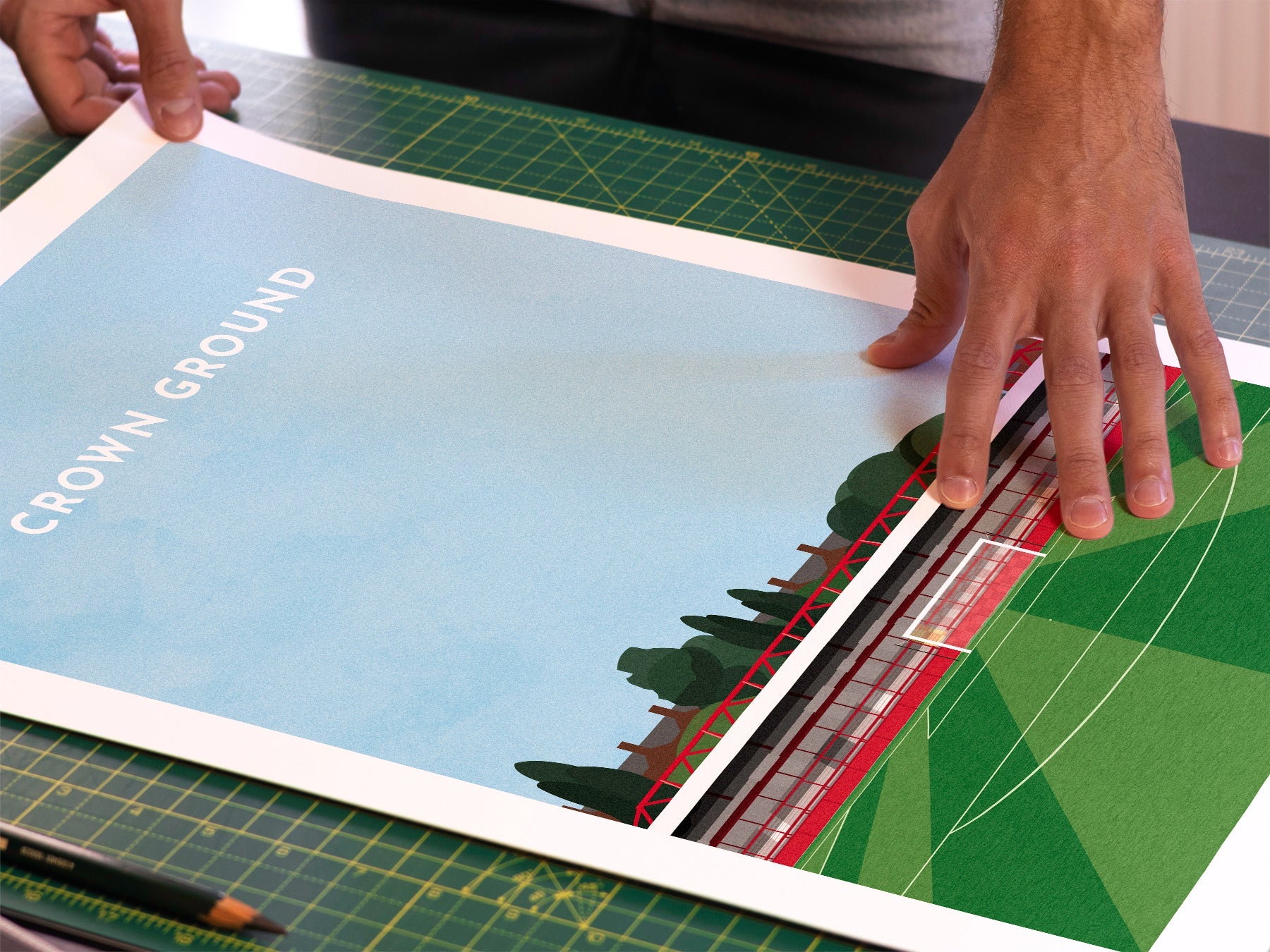 A photo in our printing studio, of one of our illustrated art prints of the Crown Ground / Wham Stadium after it has been printed and is about to be packaged.