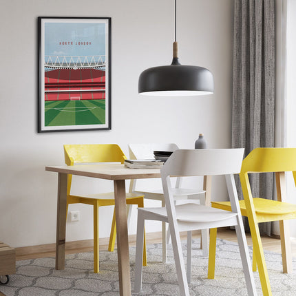 Framed illustrated print of The Emirates in North London, home to Arsenal, showcasing a minimalist design with vibrant red stands, green football pitch, under a blue sky.