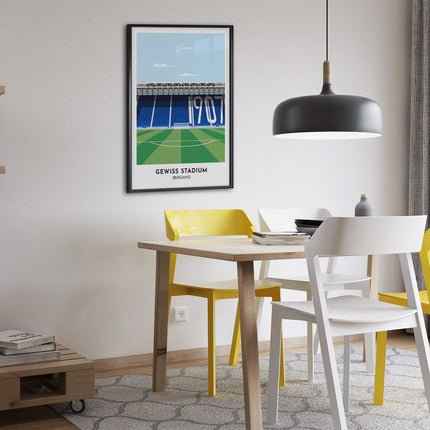 Framed illustration print of Gewiss Stadium in Bergamo, home to Atalanta, showcasing a minimalist design with vibrant blue stands, green football pitch, under a blue sky.
