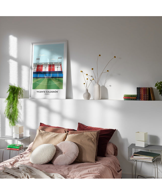 Framed illustration print of the Vicente Calderon in Madrid, former home to Atlético Madrid, showcasing a minimalist design with vibrant red, white and blue stands, green football pitch, under a blue sky.