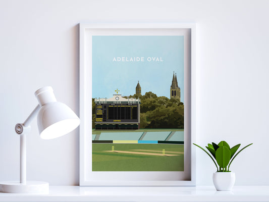 A contemporary style illustration of South Australia's cricket stadium, the Adelaide Oval, displayed as an art print within a white frame in a minimalist home office setting. 