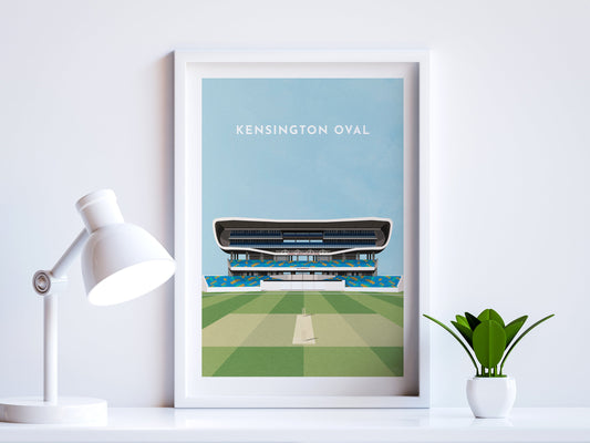 A contemporary style illustration of West Indies / Barbados cricket stadium, the Kensington Oval, displayed as an art print within a white frame in a minimalist home office setting. 