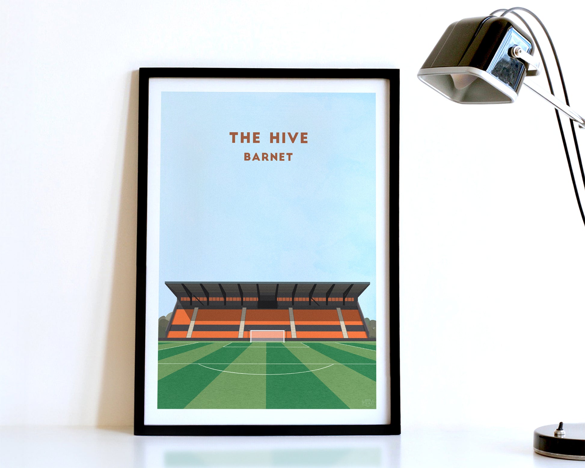 A modern style Barnet Print, featuring a contemporary illustration of their home stadium the Hive Stadium in Barnet North London, displayed within a black frame.