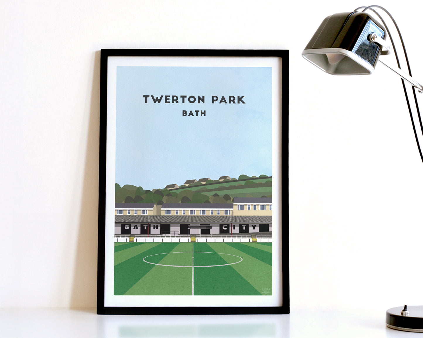A modern style Bath City Print, featuring a contemporary illustration of their home stadium the Twerton Park in Bath, displayed within a black frame.