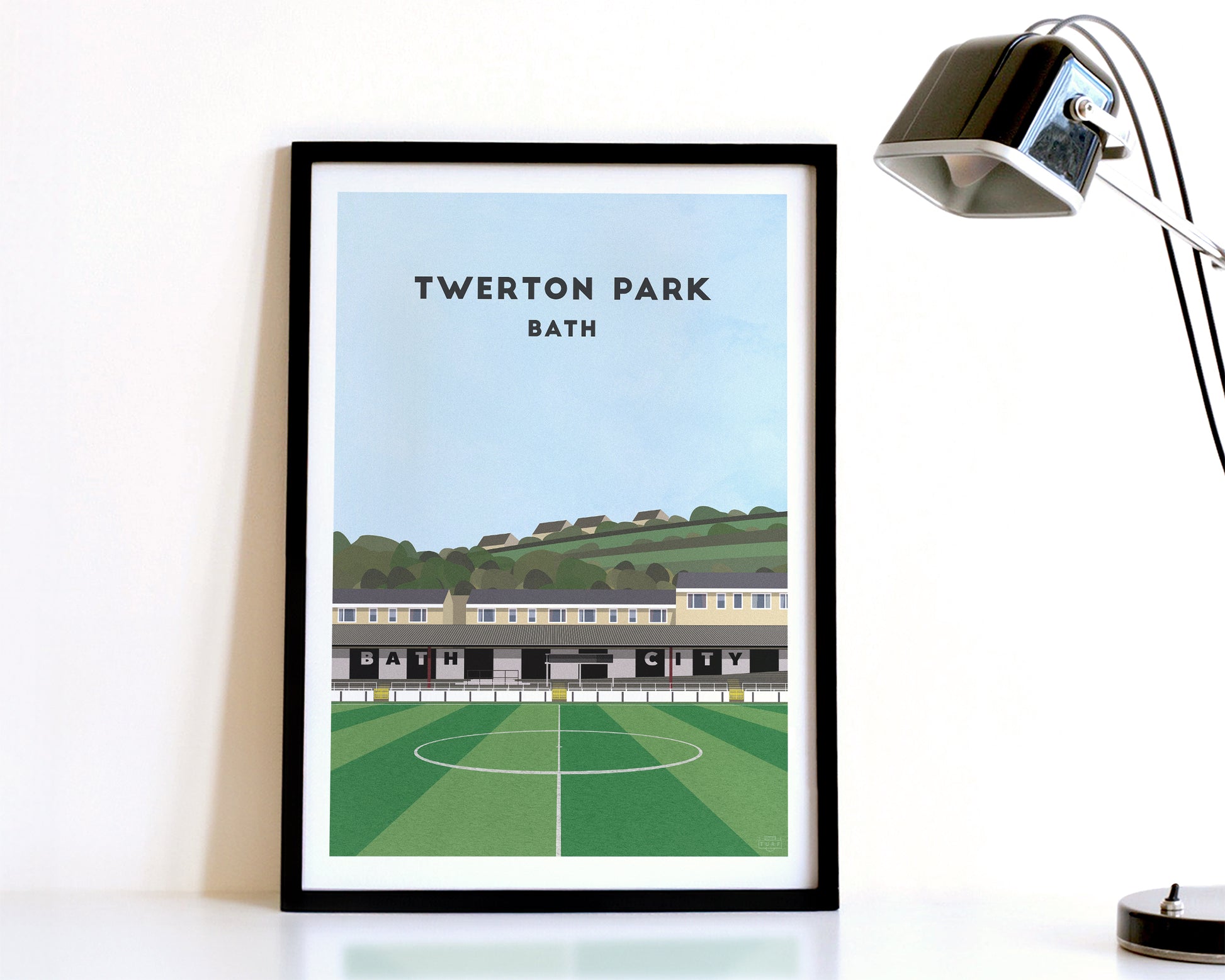 A modern style Bath City Print, featuring a contemporary illustration of their home stadium the Twerton Park in Bath, displayed within a black frame.