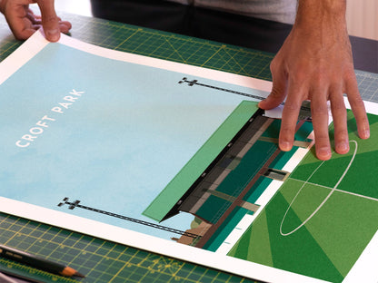 A photo in our printing studio, of one of our illustrated art prints of Croft Park after it has been printed and is about to be packaged.