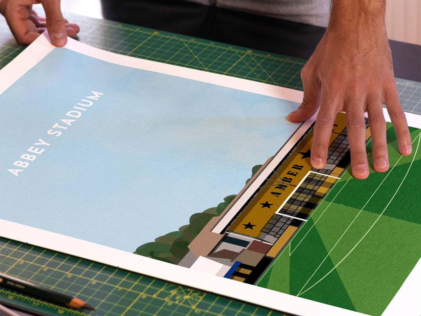 A photo in our printing studio, of one of our illustrated art prints of the Abbey Stadium after it has been printed and is about to be packaged.