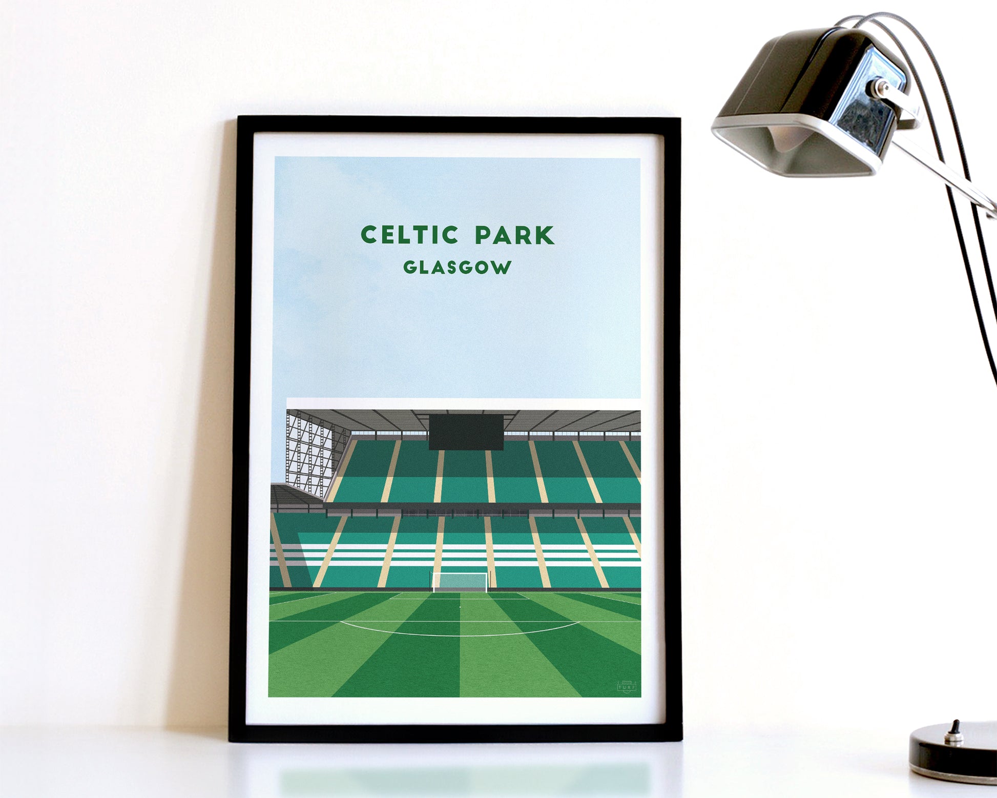 A modern style Celtic Print, featuring a contemporary illustration of their home stadium the Celtic Park in Glasgow, displayed within a black frame.