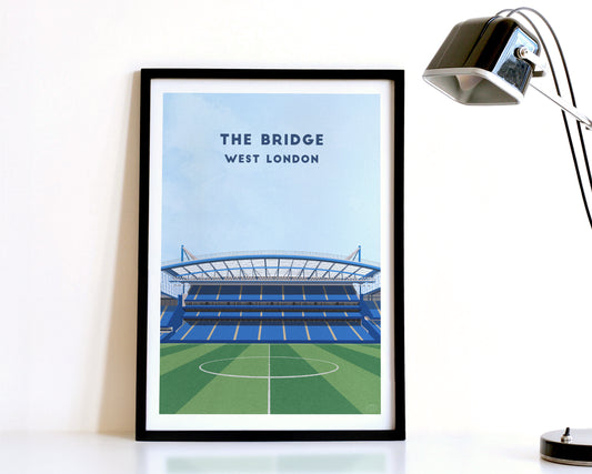 A modern style Chelsea Print, featuring a contemporary illustration of their home stadium the Stamford Bridge in West London, displayed within a black frame.
