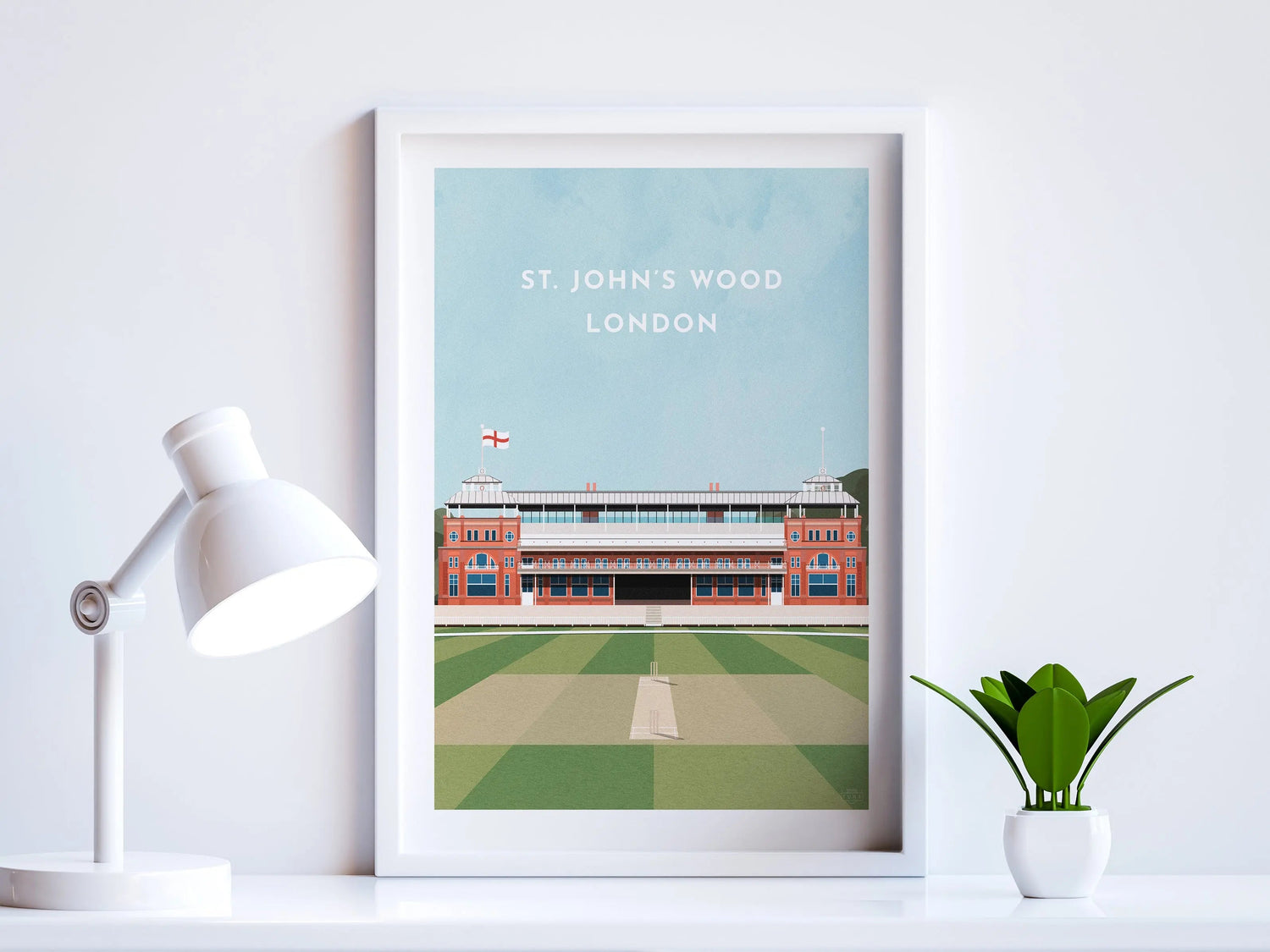 A contemporary style illustration of England cricket's ground, Lord's, displayed as an art print within a white frame in a minimalist home office setting. 