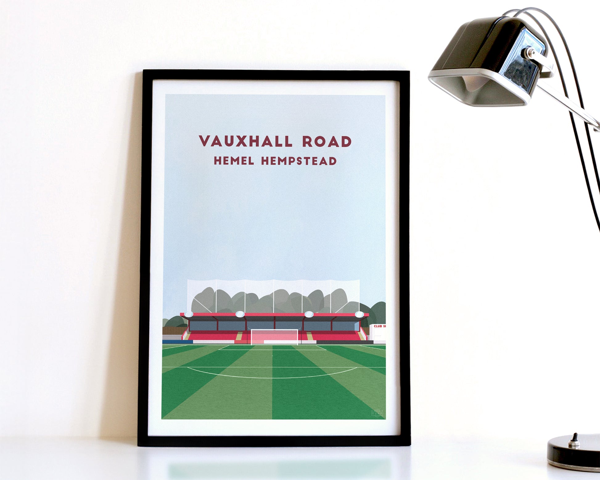 A modern style Hemel Hempstead Print, featuring a contemporary illustration of their home stadium the Vauxhall Road in Hemel Hempstead, displayed within a black frame.