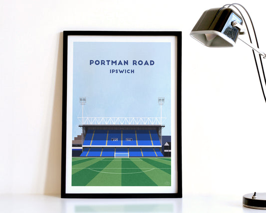 A modern style Ipswich Town Print, featuring a contemporary illustration of their home stadium the Portman Road in Ipswich, displayed within a black frame.
