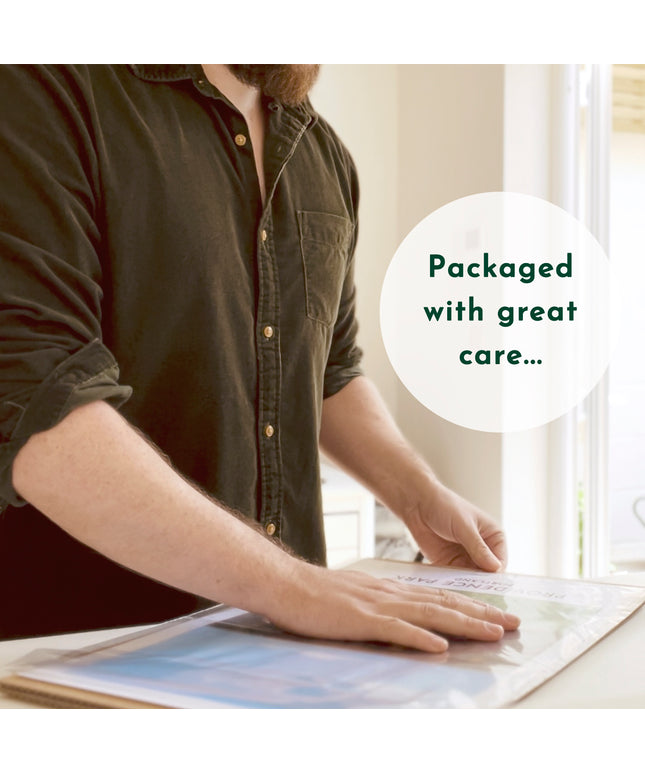 Photo of Ben carefully packaging up a customers print. Text overlay reads Packaged with great care...