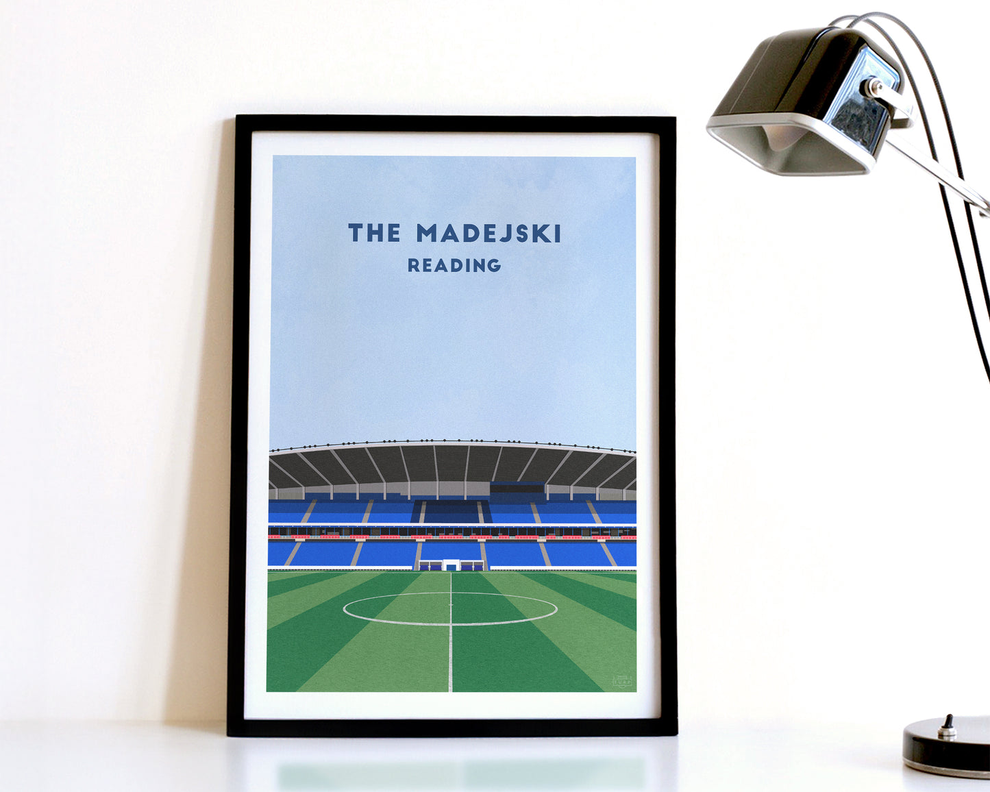 A modern style Reading FC Print, featuring a contemporary illustration of their home stadium the Madejski Stadium in Reading, displayed within a black frame.