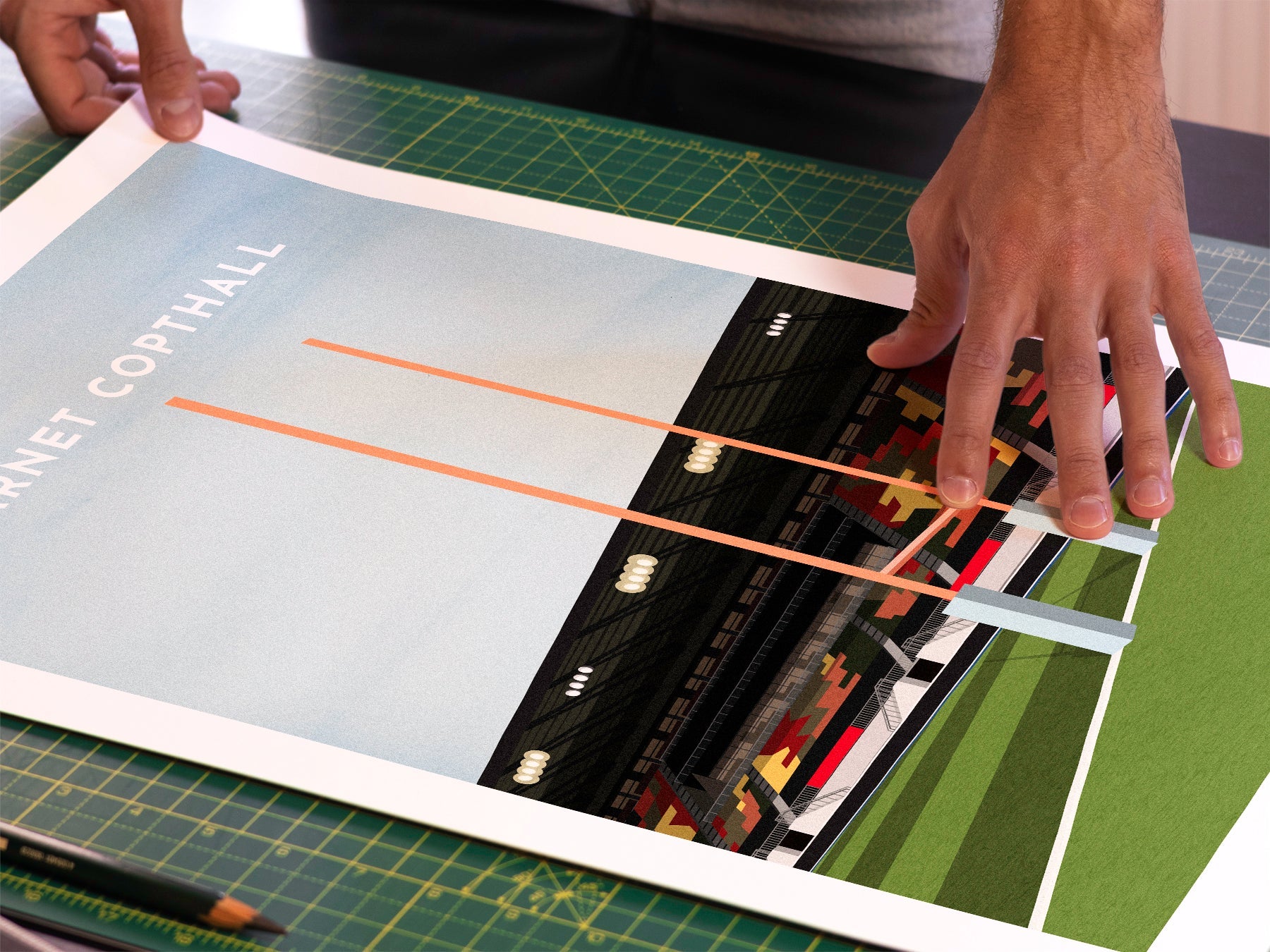 A photo in our printing studio, of one of our illustrated art prints of Barnet Copthall / StoneX Stadium after it has been printed and is about to be packaged.