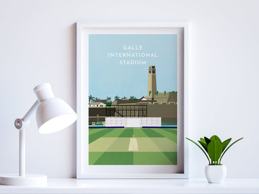 A contemporary style illustration of Sri Lanka's cricket stadium, Galle International Stadium, displayed as an art print within a white frame in a minimalist home office setting. 