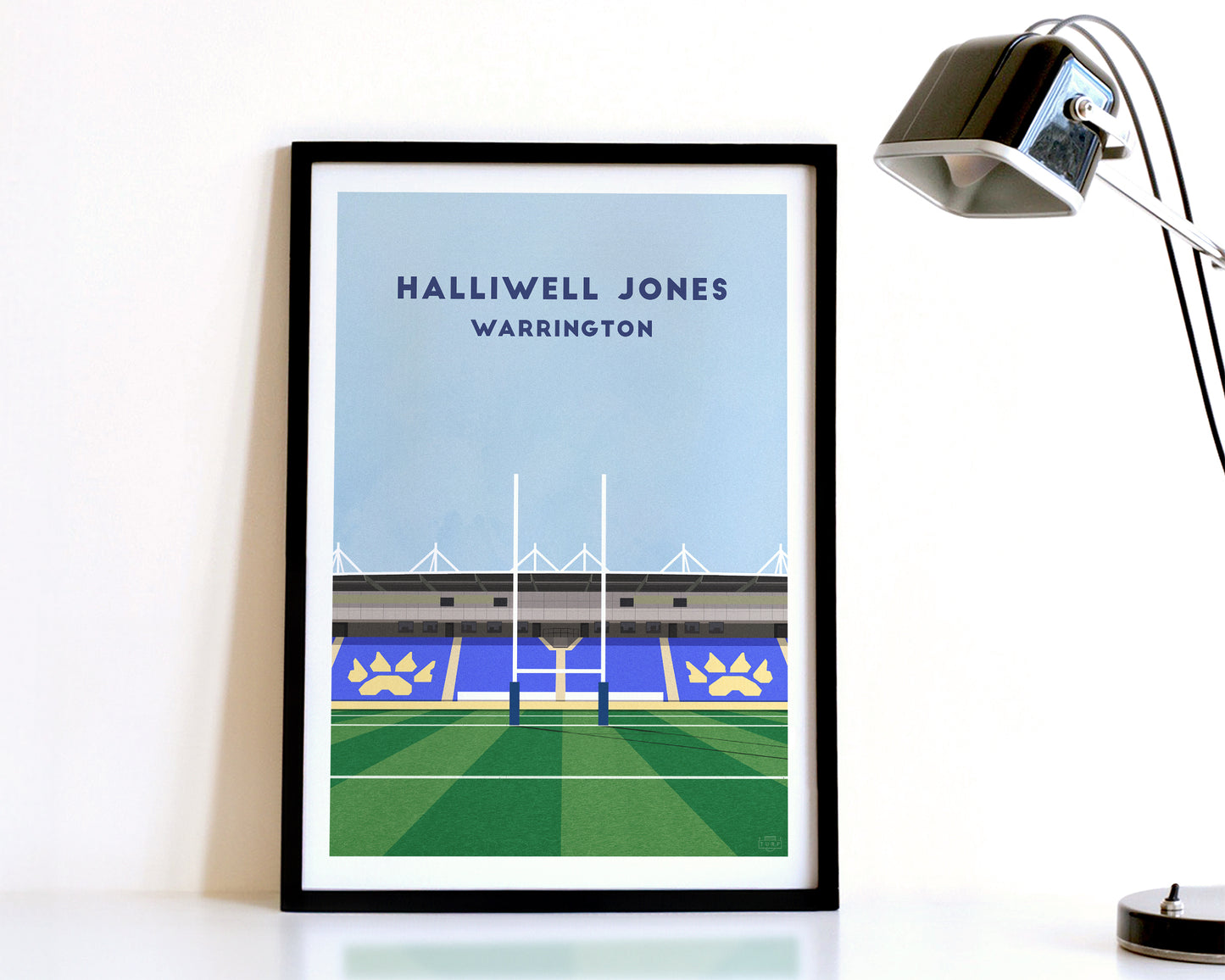 A modern style Warrington Wolves Print, featuring a contemporary illustration of their home stadium the Halliwell Jones Stadium in Warrington, displayed within a black frame.