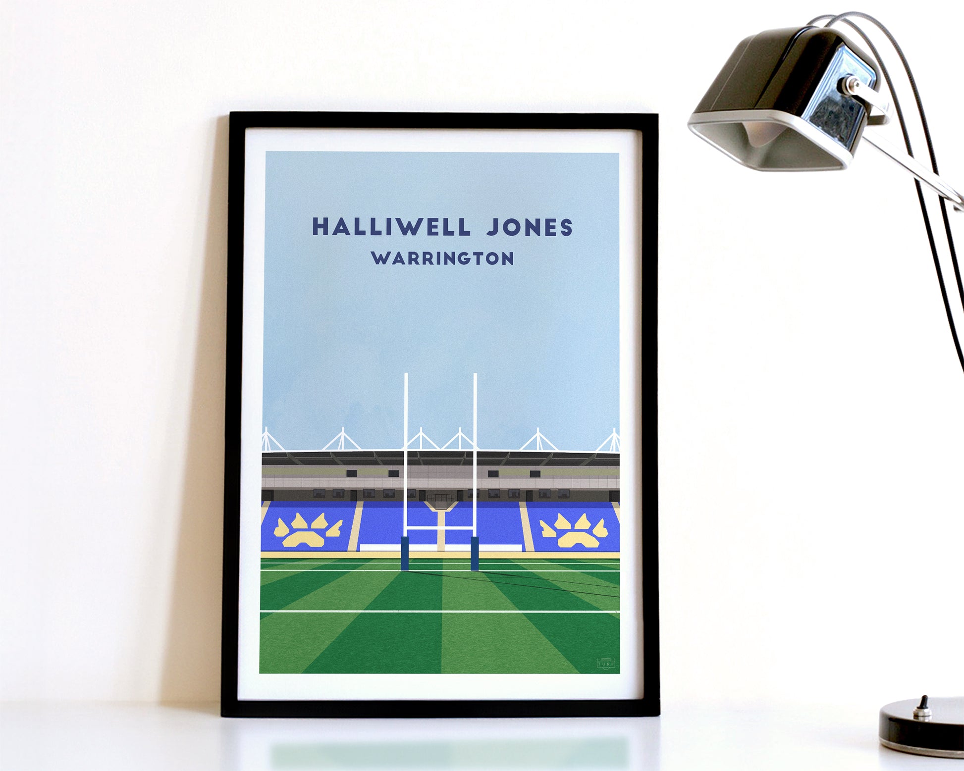 A modern style Warrington Wolves Print, featuring a contemporary illustration of their home stadium the Halliwell Jones Stadium in Warrington, displayed within a black frame.